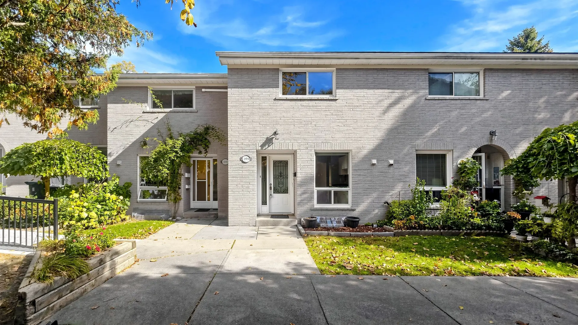 Front of 404-15 Liszt Gate, a brick townhouse with a lawn and walkway